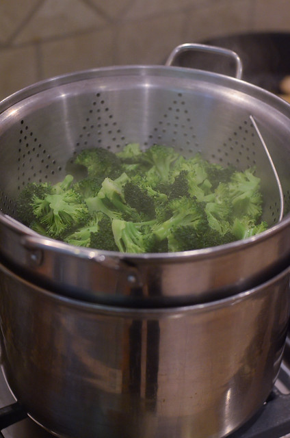 Broccoli steaming in a pasta pot.
