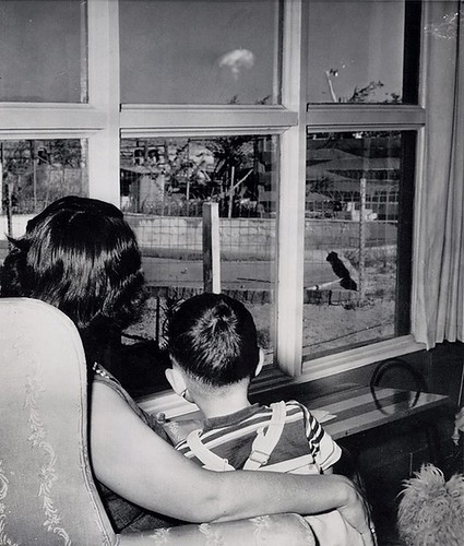 A mom and her son watch the mushroom cloud after an atomic test 75 miles away Las Vegas 1953
