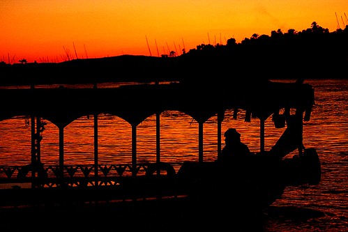 assuan sunset egypt boat nile river shade red orange sky water people summer light