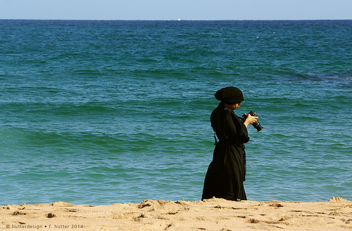 blue sea woman black water photo sand waves wind cloth burqa chador omansea