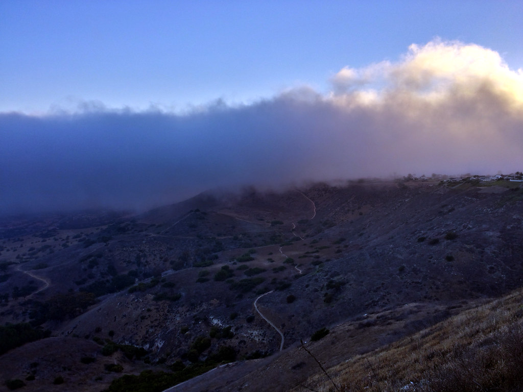 Backlit Fog Creeping Over the Hills