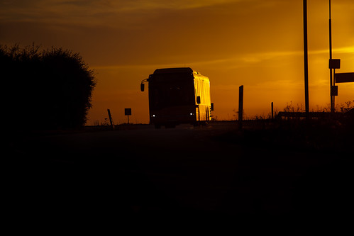 road sunset sky orange lund bus public evening coach europe driving sweden dusk transport headlights late sverige posts approaching zweden motorcoach 200mm fav10 skånetrafiken ef70200mmf4lusm canoneos5dmarkii