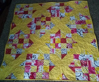 A quick finish tonight after I uncovered the sewing machine. Everything is back in the closet that is going back in there. Goodnight Irene using yellow, black, white, and pink scraps. Baby playmat quilt size.