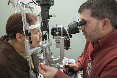 Dr. Will Phillips, right, conducts an eye exam for Ann Haddox in the Dena'ina Wellness Center's new optometry office.