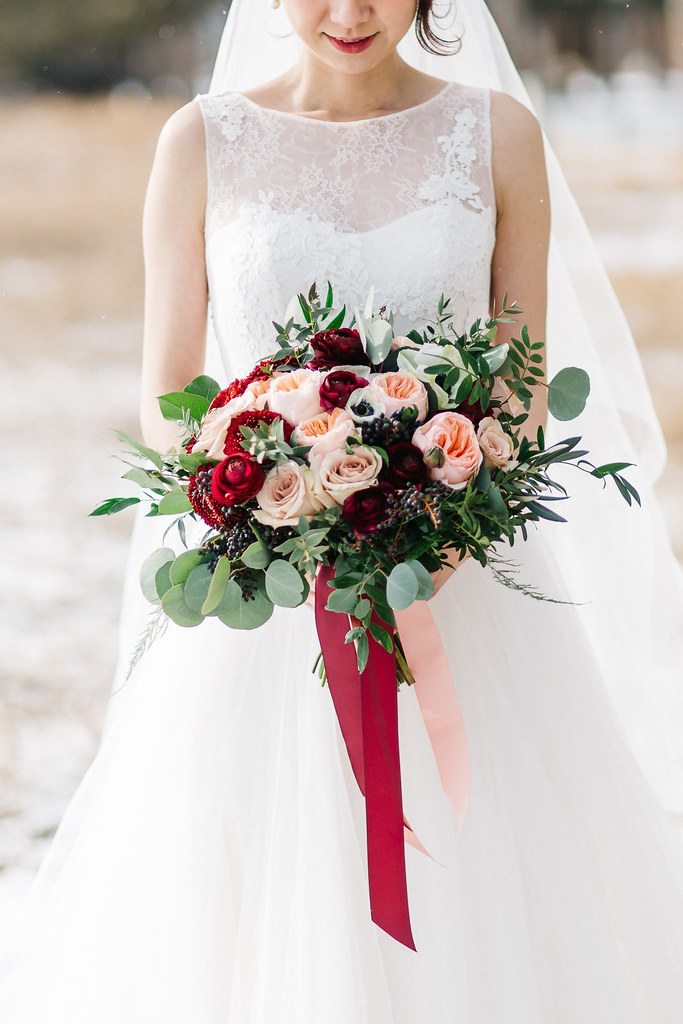 Bow Valley Ranche Wedding Calgary, Bride with winter bouquet of Juliet garden roses and wine coloured ranunculus, Flowers by Janie