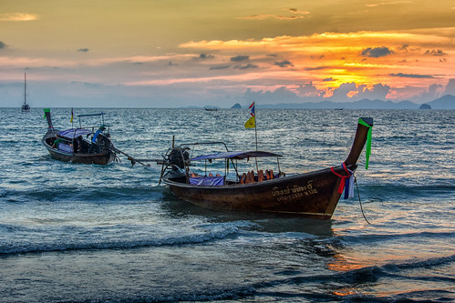 ocean street sunset red sea sky reflection beach water yellow dark thailand boats lights coast twilight long waves afternoon view nocturnal nightshot district tide tail wave coastline ripples hue tidal current longtailboat krabi aonang