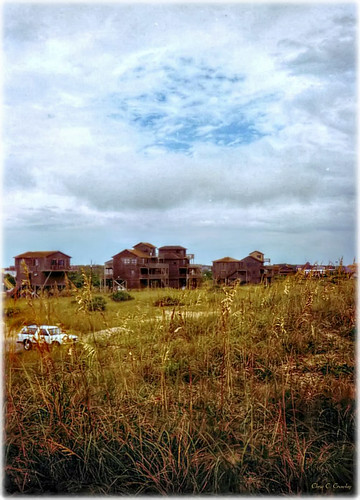 capehatterasview landscape scenic capehatterasnorthcarolina rainy stormy cloudy overcast clouds grass beachhouses car