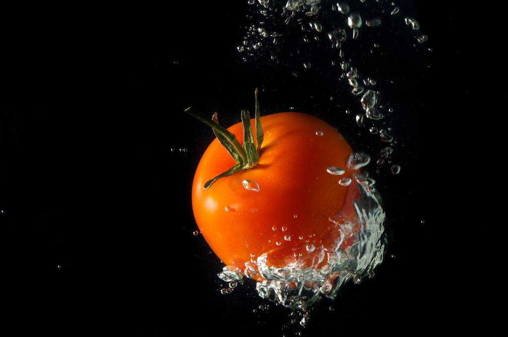 fresh red tomato dropped in water, photographic art, for home and office décor.