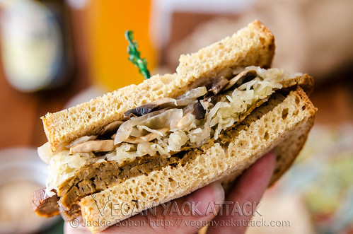 A delectably savory Seitan Sauerkraut Sandwich, complete with mushrooms, onions and horseradish sauce on toasted wheat bread!