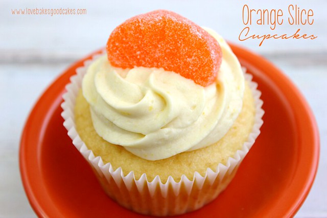 Orange Slice Cupcake in orange bowl with an orange candy on top close up.