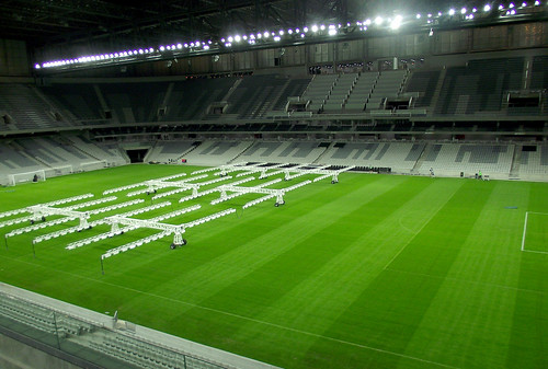 Workers irrigate University of Georgia-licensed TifGrand turfgrass after it is installed in Arena da Baixada in Curitiba, Brazil, one of three World Cup stadiums to use the turf this year. Photo Credit: University of Georgia
