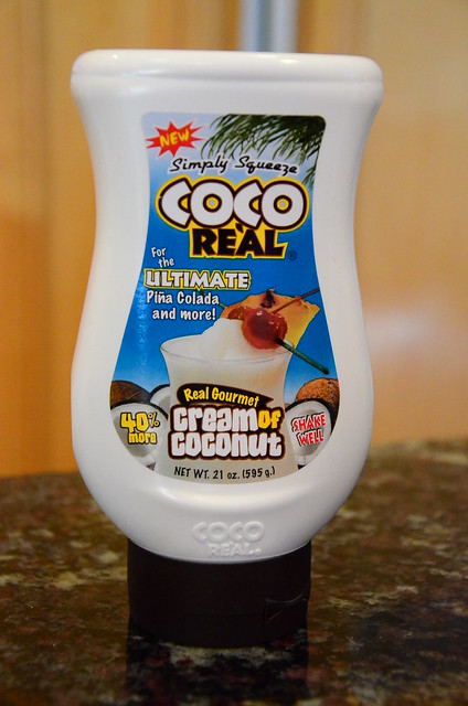 A close up view of the cream of coconut bottle.