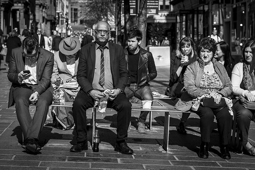 people monochrome urban street candid portrait streetphotography candidstreetphotography streetlife sociallandscape man male woman female face faces facial expression look emotion feeling bench sitting gender difference contrast eating hat mobile lunch tone texture detail depth naturallight outdoor sunlight light shade shadow city scene human life living humanity society culture canon canon5d 5dmarkiii character 70mm ef2470mmf28liiusm black white blackwhite bw mono blackandwhite glasgow scotland uk