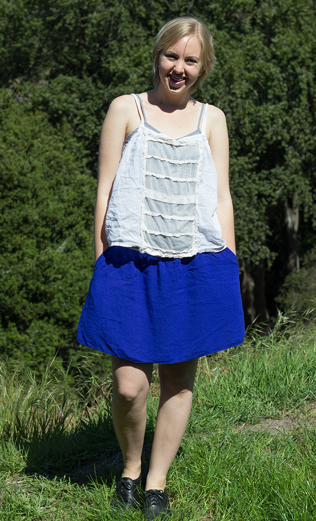 summery outfit: floaty white tank top, short blue skirt