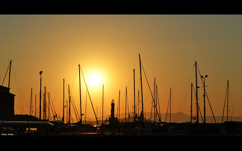 old sunset sky orange sun lighthouse port landscape harbor daylight boat colorful europe day sailing shadows harbour south sails aegean greece crete end masts chania