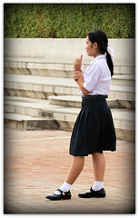 Playful Schoolgirl at Tha Tien Pier Area, Bangkok, Thailand