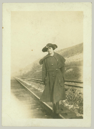 Girl with hat on the railroad tracks