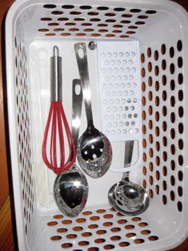 Basket of child-size utensils kept in the kitchen for a child to help prepare dinner. (Photo from The Montessori Child at Home)