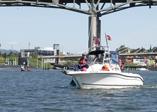 Members of the Coast Guard Auxiliary help to maintain a security zone along the Willamete River in Portland, Ore., during the Rose Festivial, June 7, 2014. Coast Guard personnel, along with state law enforcement agencies and Coast Guard Auxiliary, maintained a strict security zone to ensure the protection of everyone who attended the Rose Festival's events. U.S. Coast Guard photo by Petty Officer 3rd Class Jordan Akiyama.