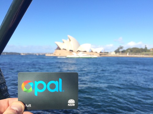 Adult Opal Card held infront of Sydney Opera House