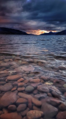 doresbeach stones pebbles water lochness fireinthesky clouds transparent clearwater scotland north highlands uk unitedkingdom fire dramatic calmness evening dusk lowdown angle perspective sutherland marksutherland snapseed smartphone androidography samsung galaxys7 effect postediting cameraphone cellphone phoneography ripples atmospheric amaturephotographer sunset dark sky landscape scottishlandscape