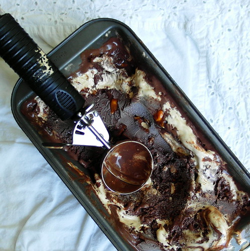 Triple Chocolate Coffee Peanut Crunch Gelato in a metal loaf pan with an ice cream scoop.