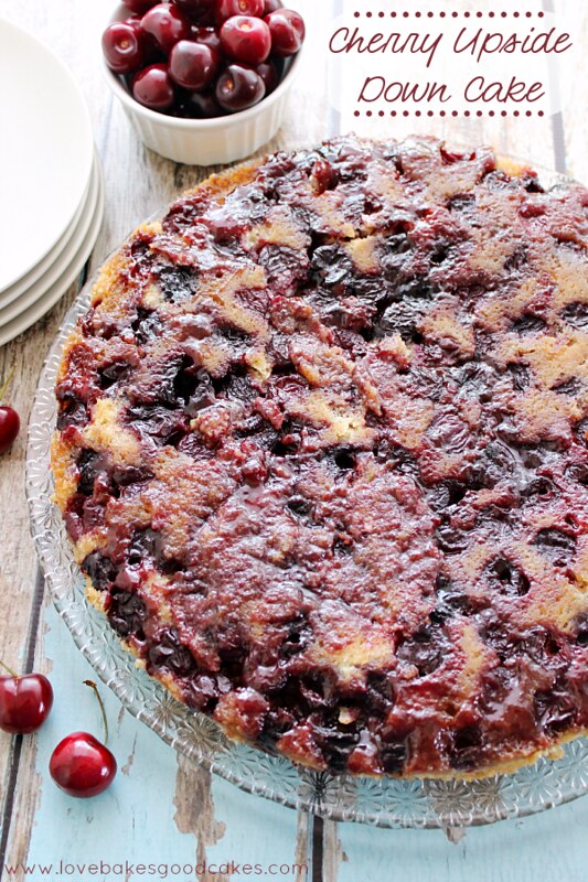 Cherry Upside Down Cake in a dish with fresh cherries.