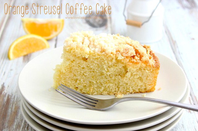Orange Streusel Coffee Cake on white plate with a fork.