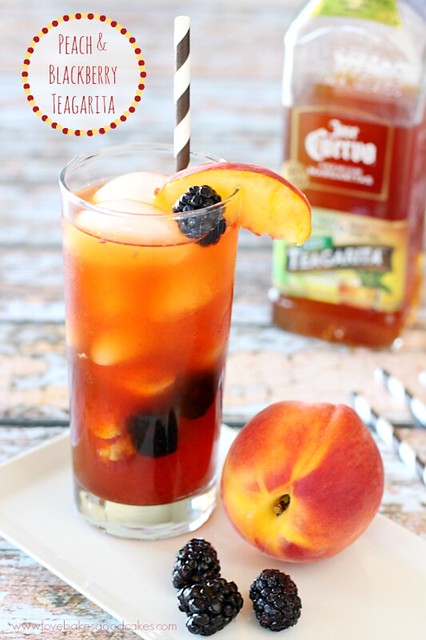 Peach and Blackberry Teagarita in a glass with fresh peaches and blackberries.