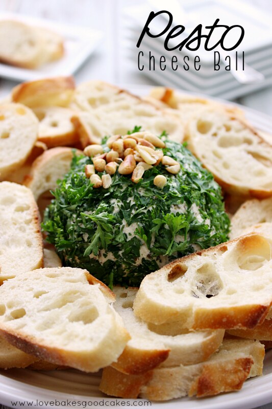 Pesto Cheese Ball with bread slices on a plate.
