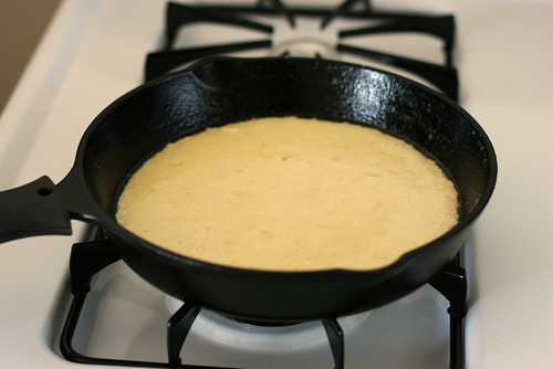 Slightly lumpy batter added to a well-buttered pan