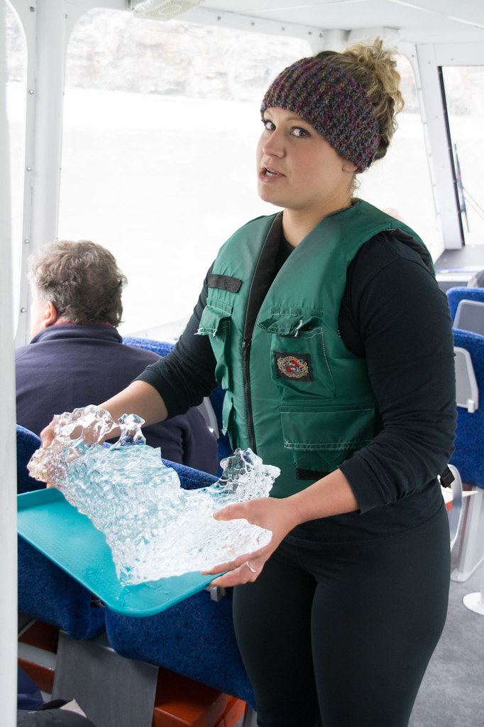 Tour guide holding piece of iceberg