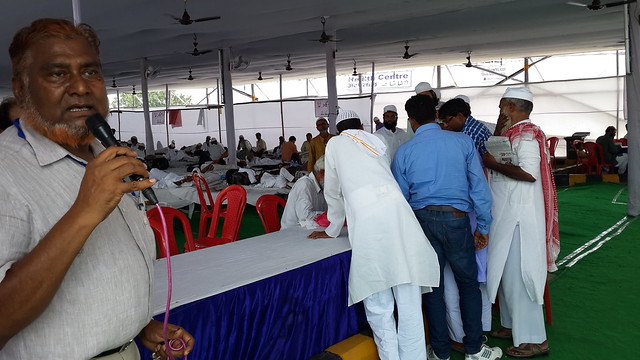 Dr Hamid Hussain gives instructions to Hajis and volunteers.