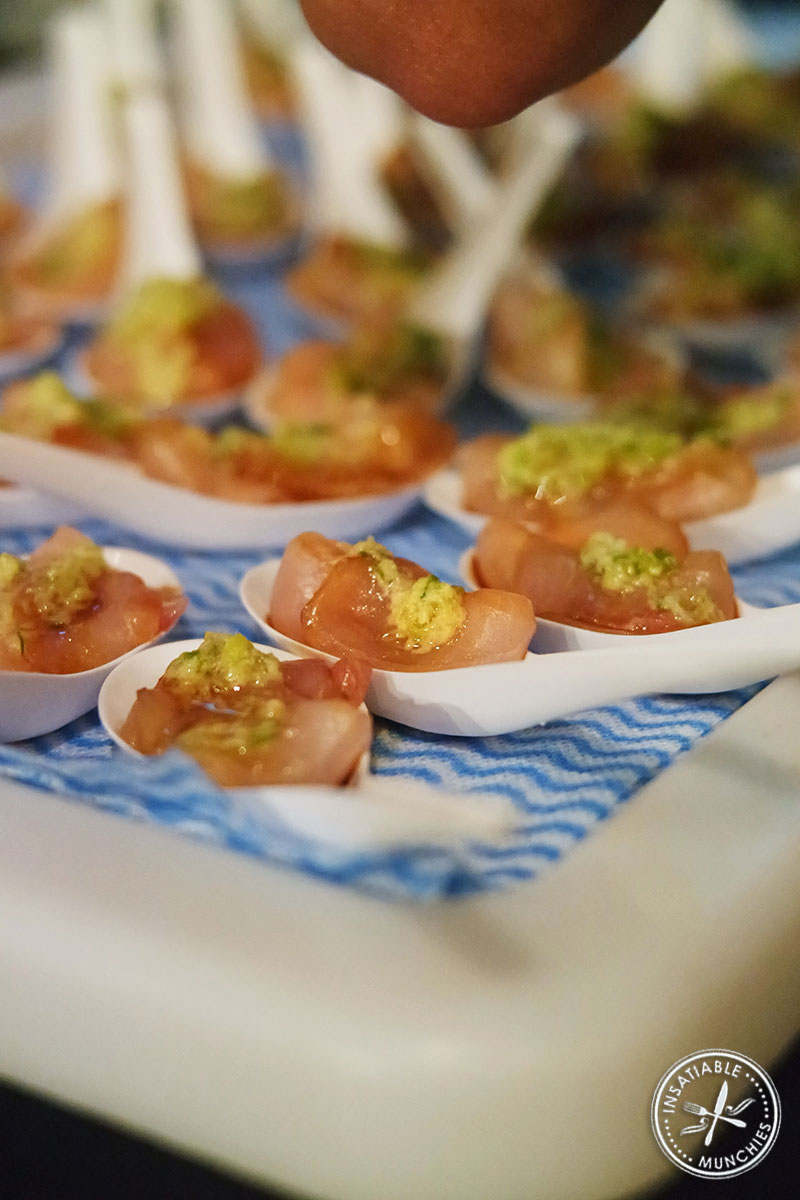 Slices of kingfish placed into Chinese spoons for a canapé. 