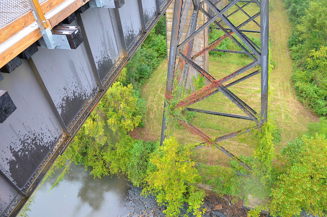 Bridge structure and view of the Appomattox River from the bridge - Interpreter Bob Flippen takes visitors on a tour under the bridge at High Bridge Trail State Park, Virginia