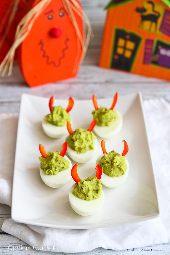 Devilish Avocado Sriracha Deviled Eggs...A fun & healthy snack for Halloween! 52 calories and 1 Weight Watchers point per serving. | cookincanuck.com #recipe #appetizer #vegetarian #glutenfree
