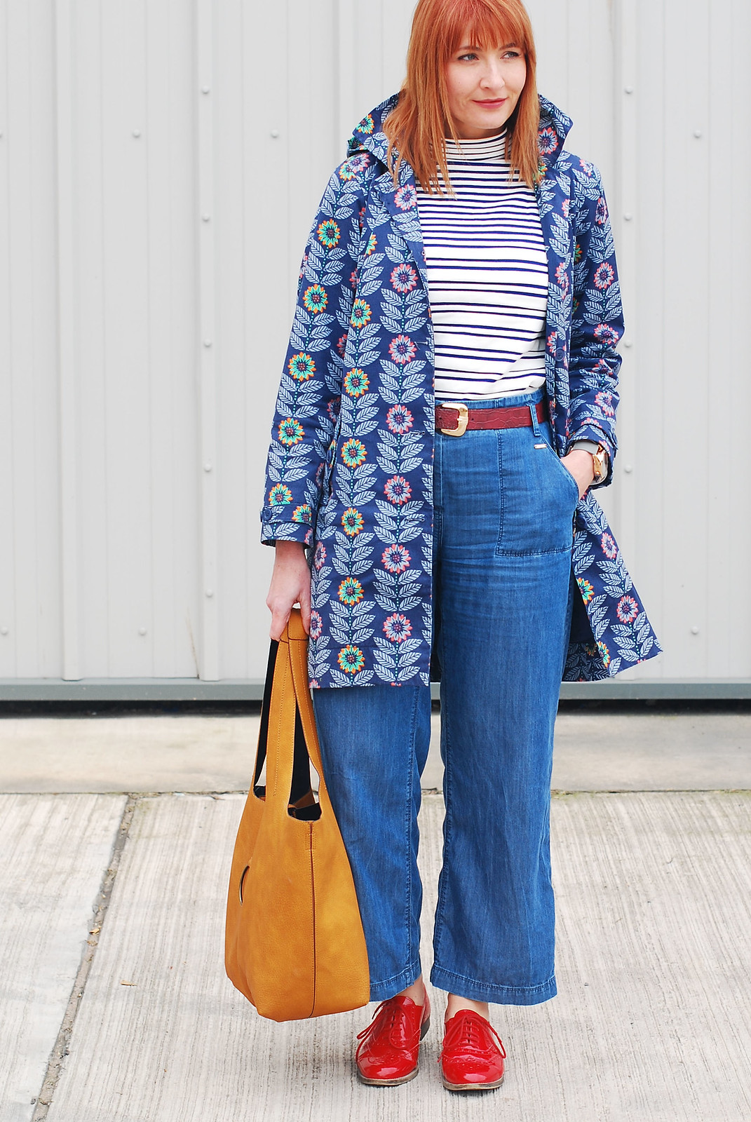 Bright spring weather outfit: Floral Seasalt raincoat high neck stripe Breton top wide leg cotton denim trousers red brogues ochre bucket bag | Not Dressed As Lamb, over 40 style