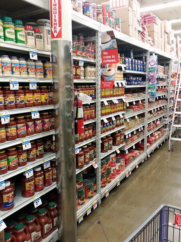 A grocery store isle with products on the shelf.